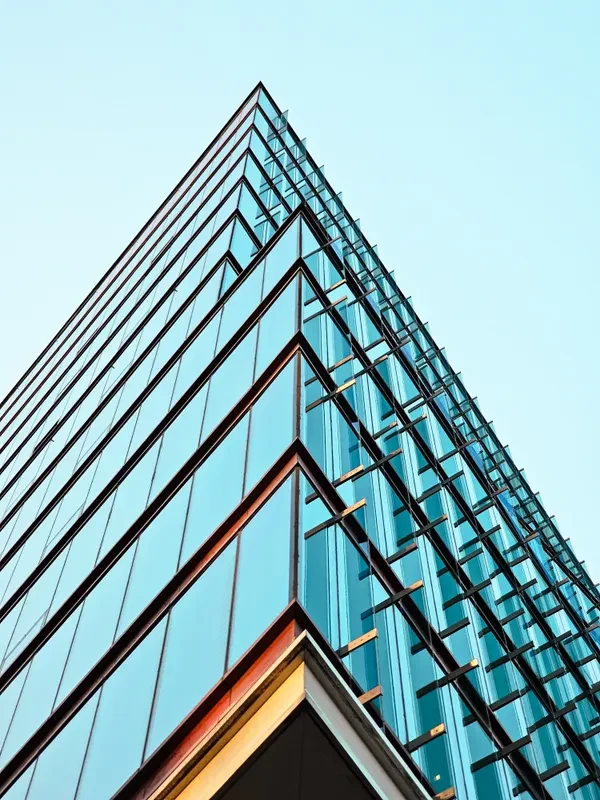 Modern glass office tower viewed from below